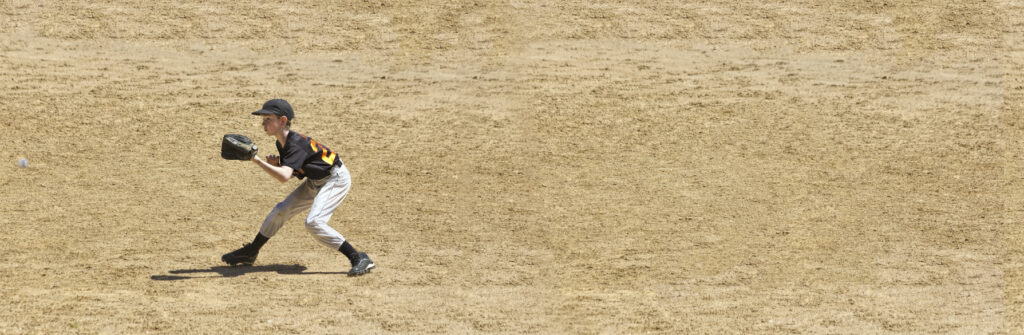 Youth baseball player catching line drive